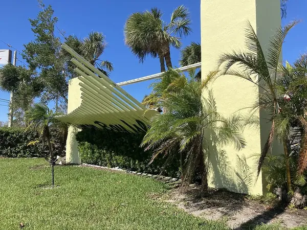 White aluminum structure bent against a wall after Hurricane Ian, Englewood, FL
