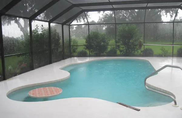 Rain on the mesh walls of a pool screen cage