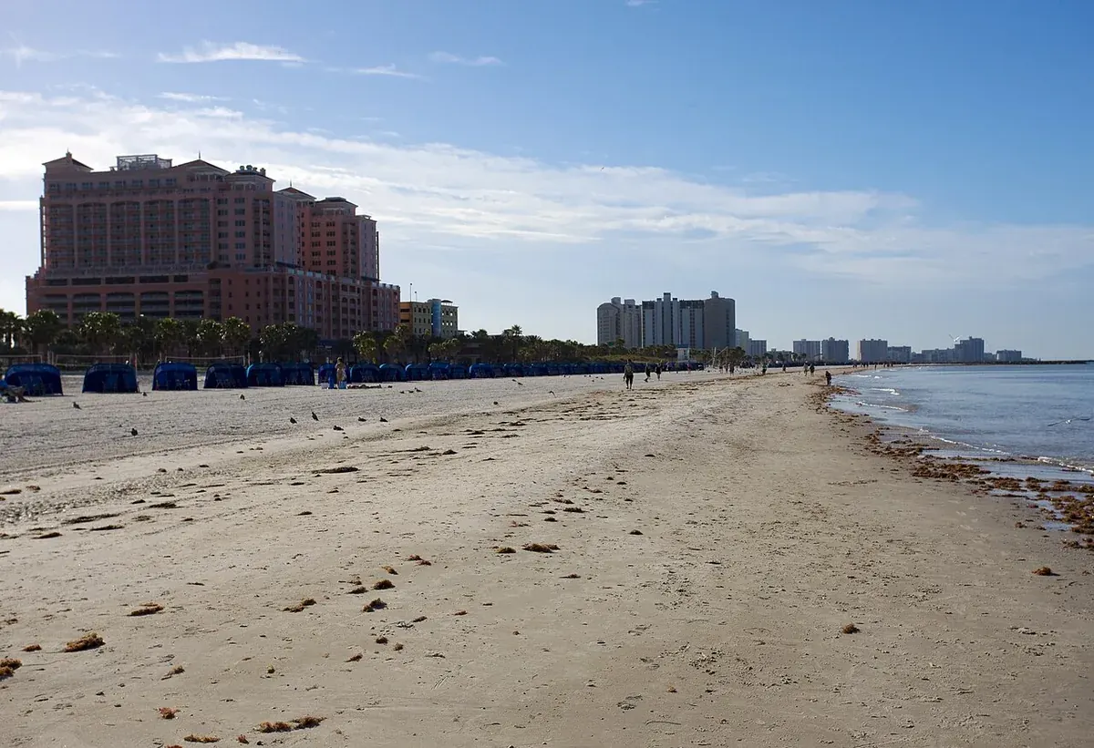 Wide sandy Clearwater Beach with hotels and condos along the shoreline in Clearwater, FL