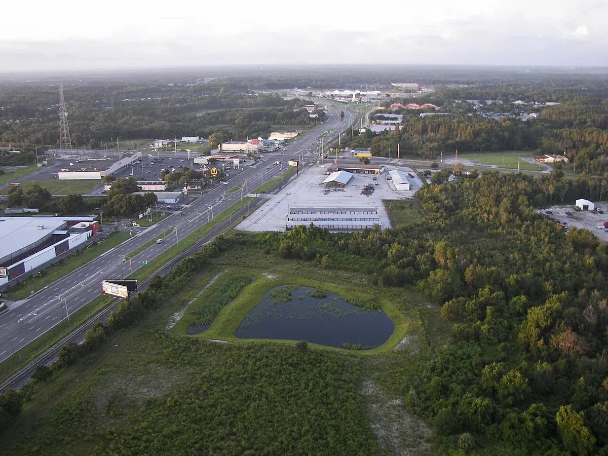 Aerial view of Land O' Lakes, FL over US 41 and SR 54 with ponds, woods and shopping centers