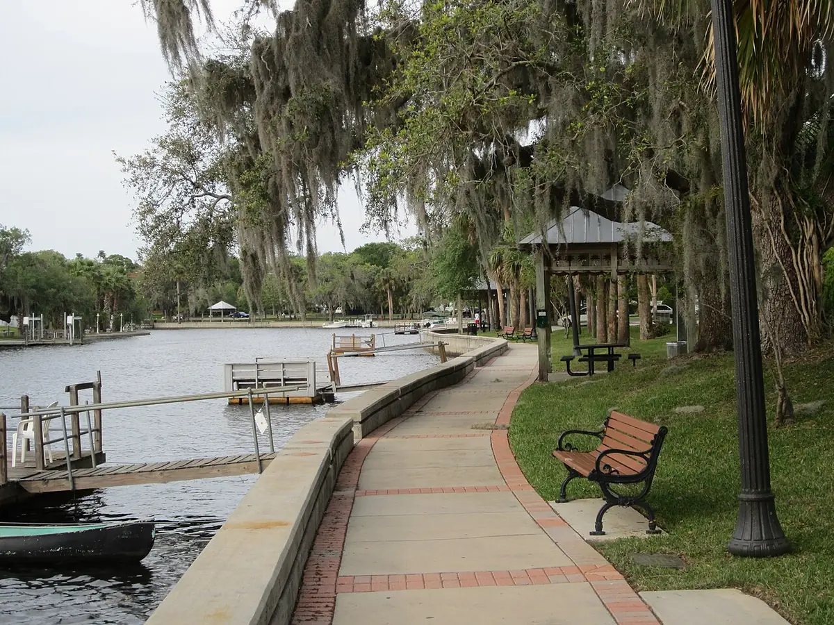 Riverside walkway, gazebo and docks along the Cotee River in New Port Richey, FL under mossy oaks