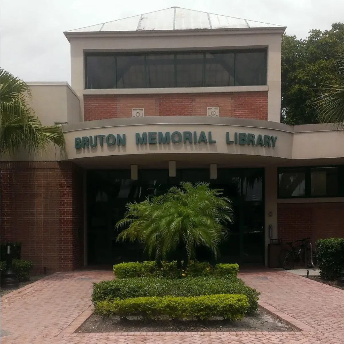 Entrance of the brick Bruton Memorial Library with a palm in a planter, Plant City, FL
