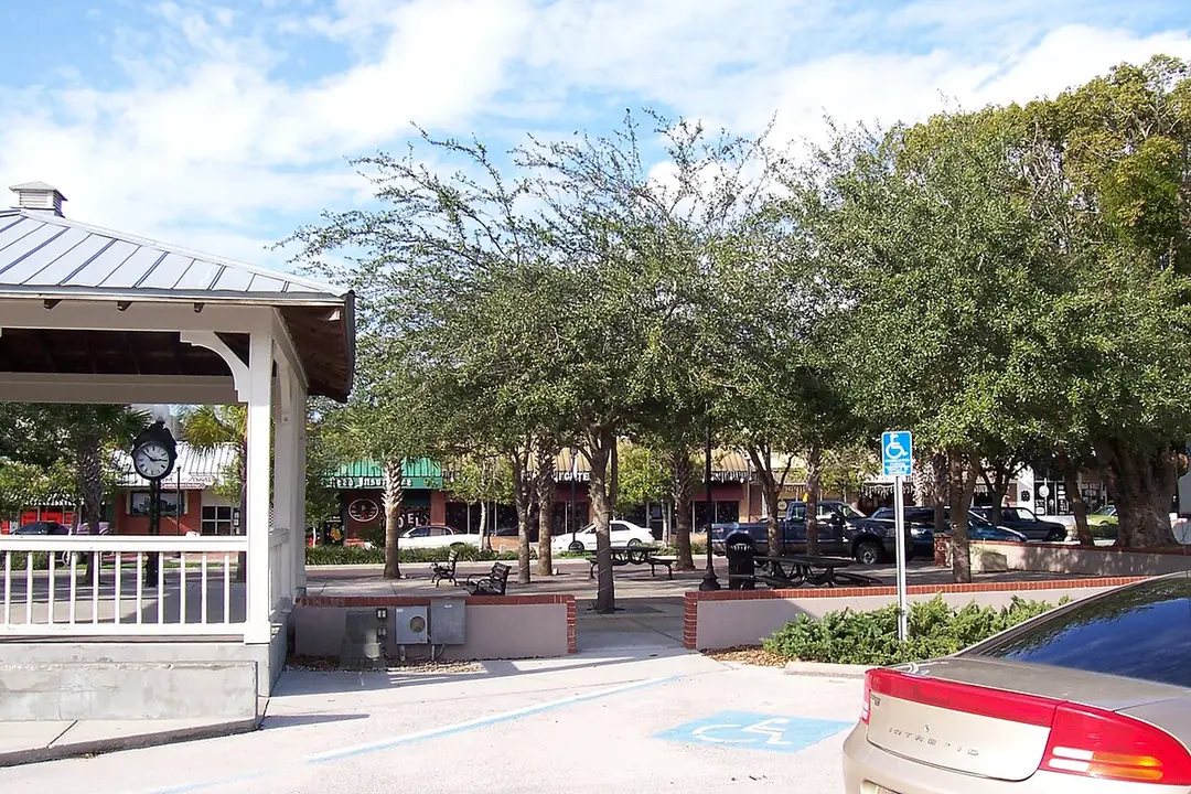 Downtown Zephyrhills, FL plaza with a white gazebo, street clock and oak trees